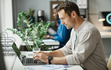 Man Working at Computer in Office Side View